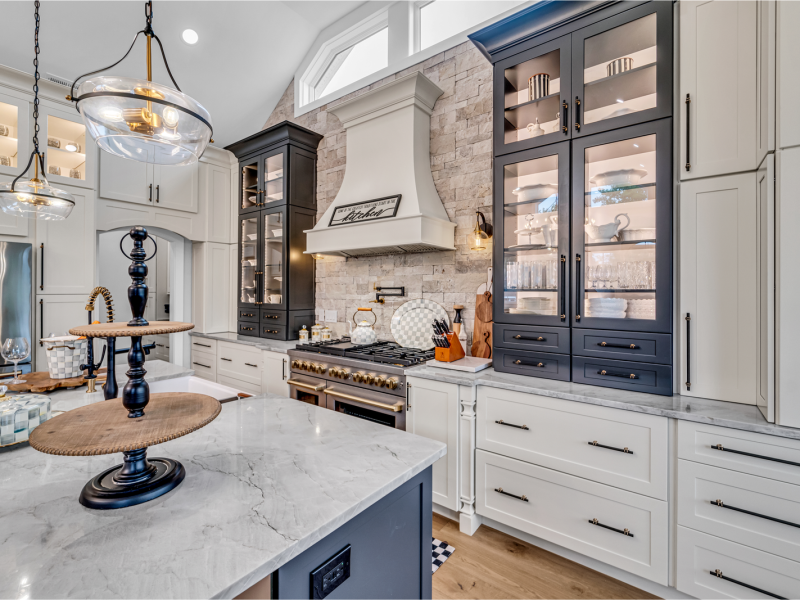 Open-concept kitchen with marble island and statement pendant lighting