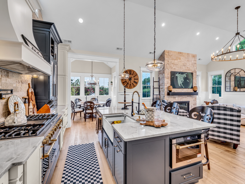Premium kitchen with stone hood, glass-front cabinets and quartzite counters